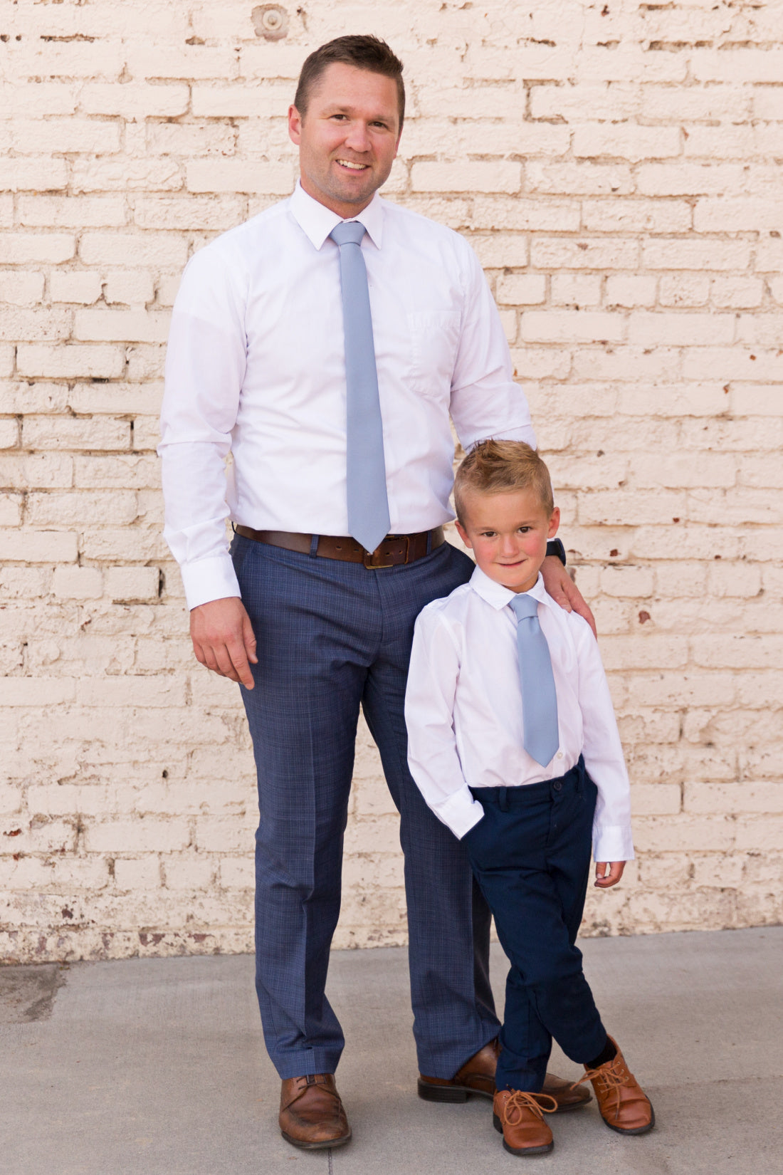 Man and boy wearing dusty blue tie