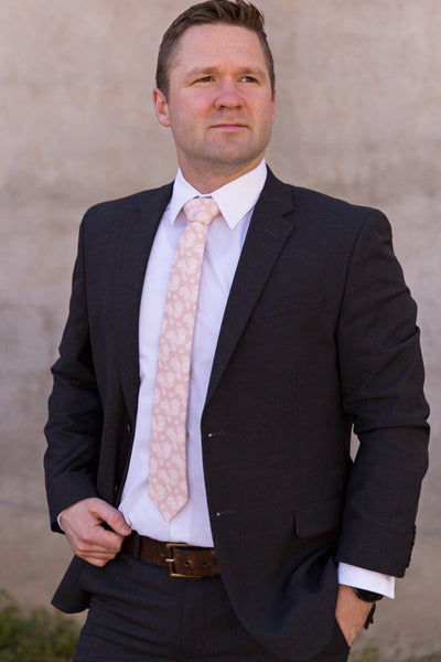 Man wearing blush palm leaves tie