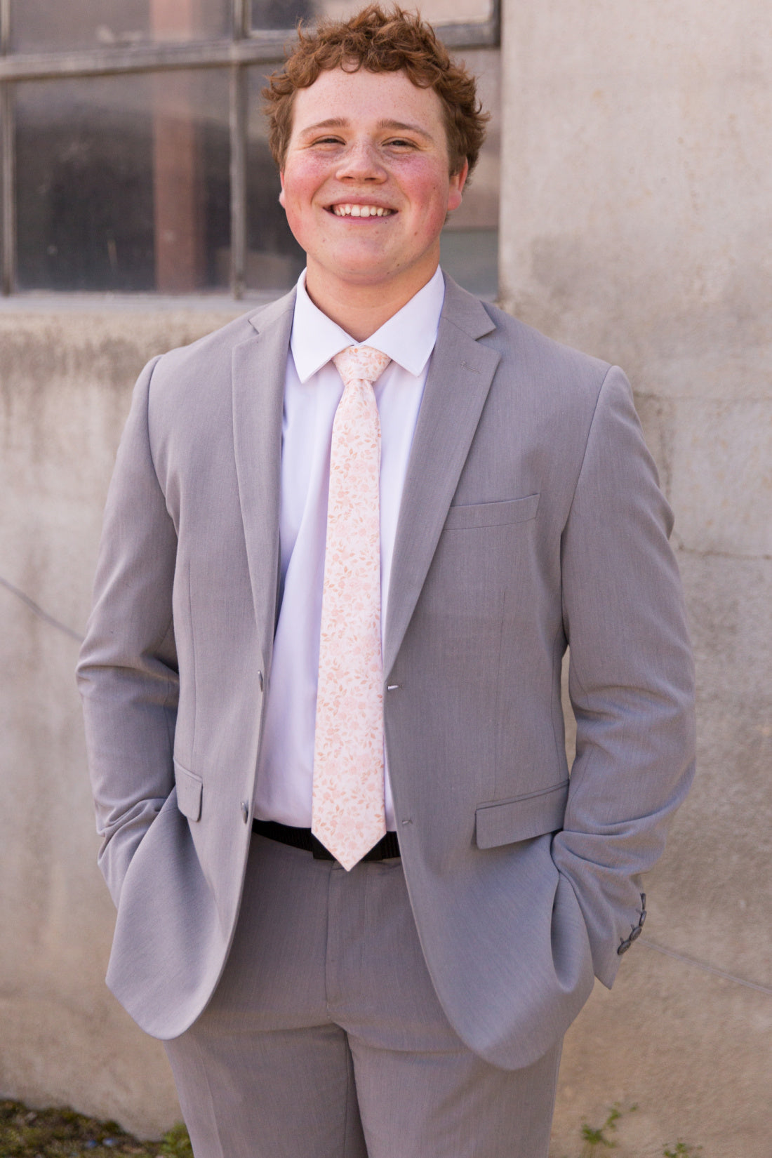 Young man wearing blush floral tie