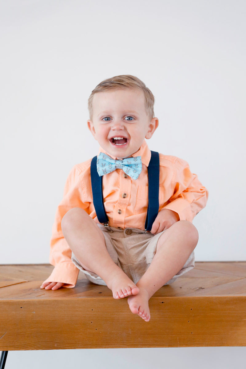 Boy wearing easter bow tie and suspenders.