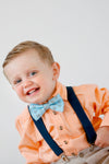 Boy wearing easter bow tie and suspenders.